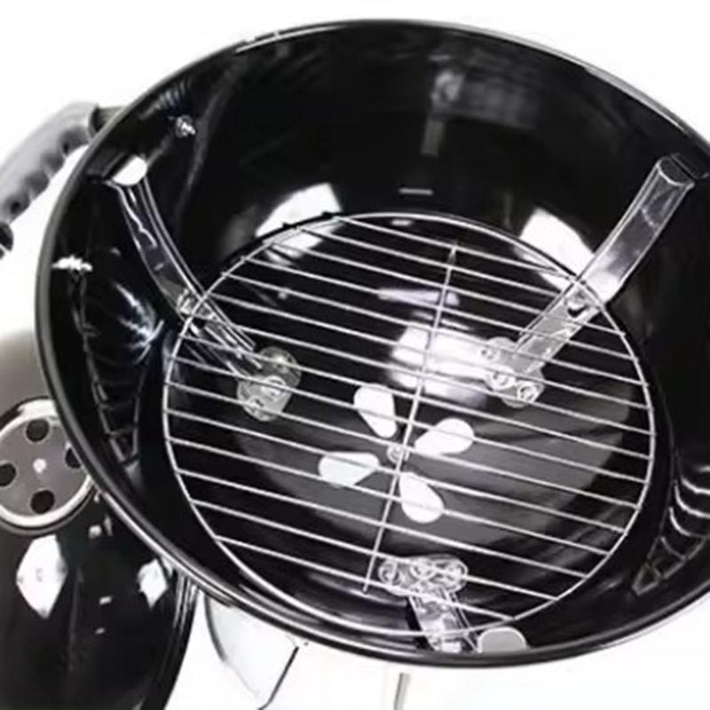 Detailed view of the interior of a portable outdoor extra-large round charcoal grill