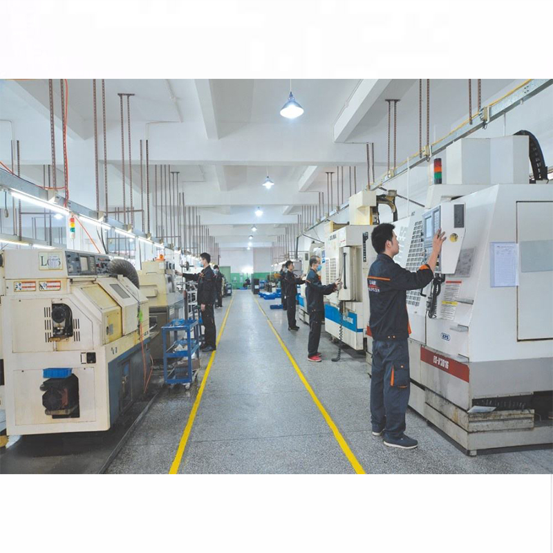 Shows a factory workshop where CNC machine tools are in operation.