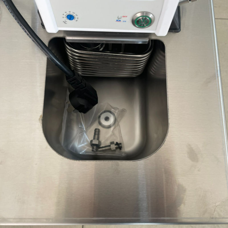 Benchtop water bath and circulator maintaining constant high temperature.